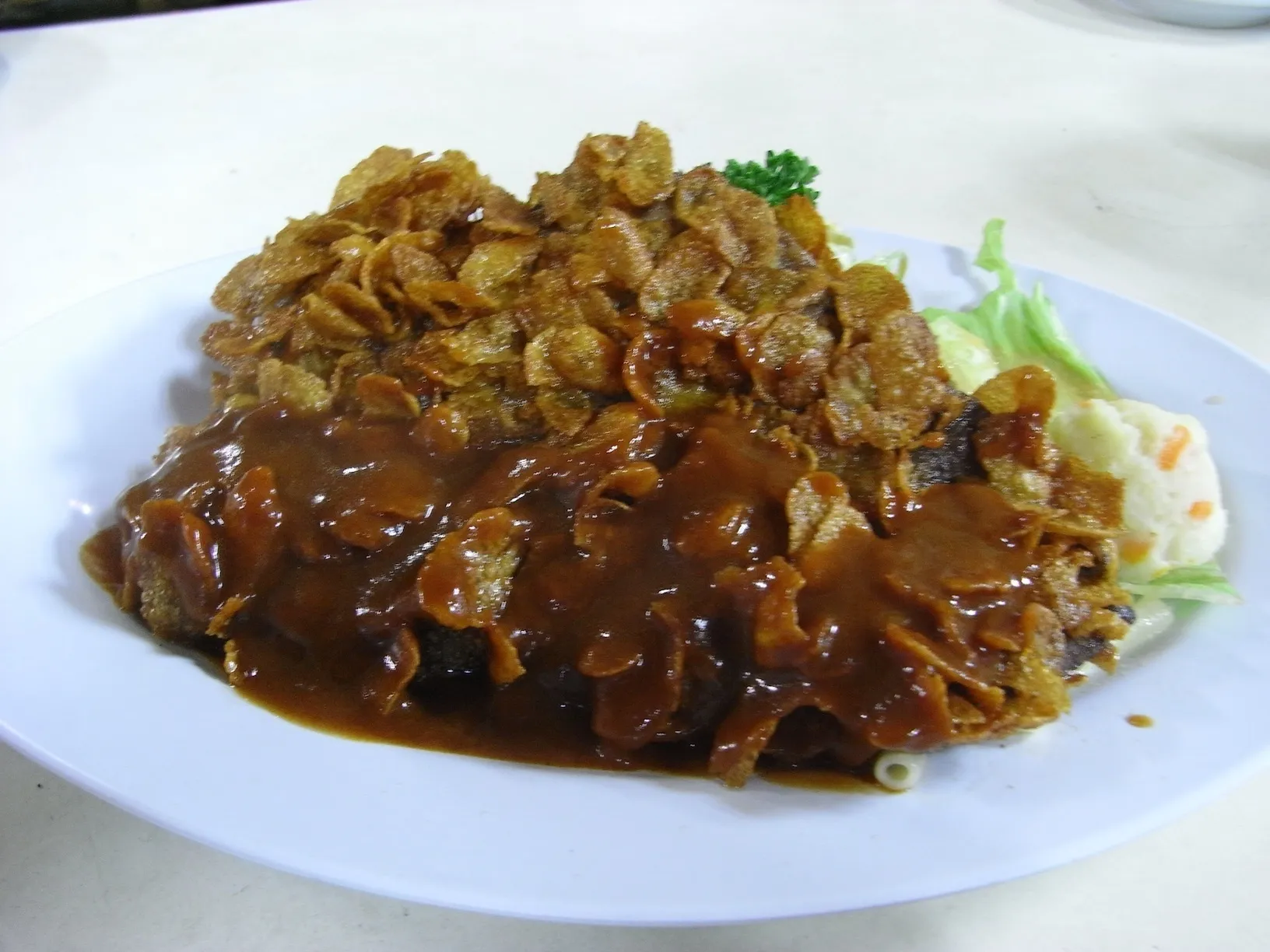 名物コーンカツにデミグラスソースをかけた一皿